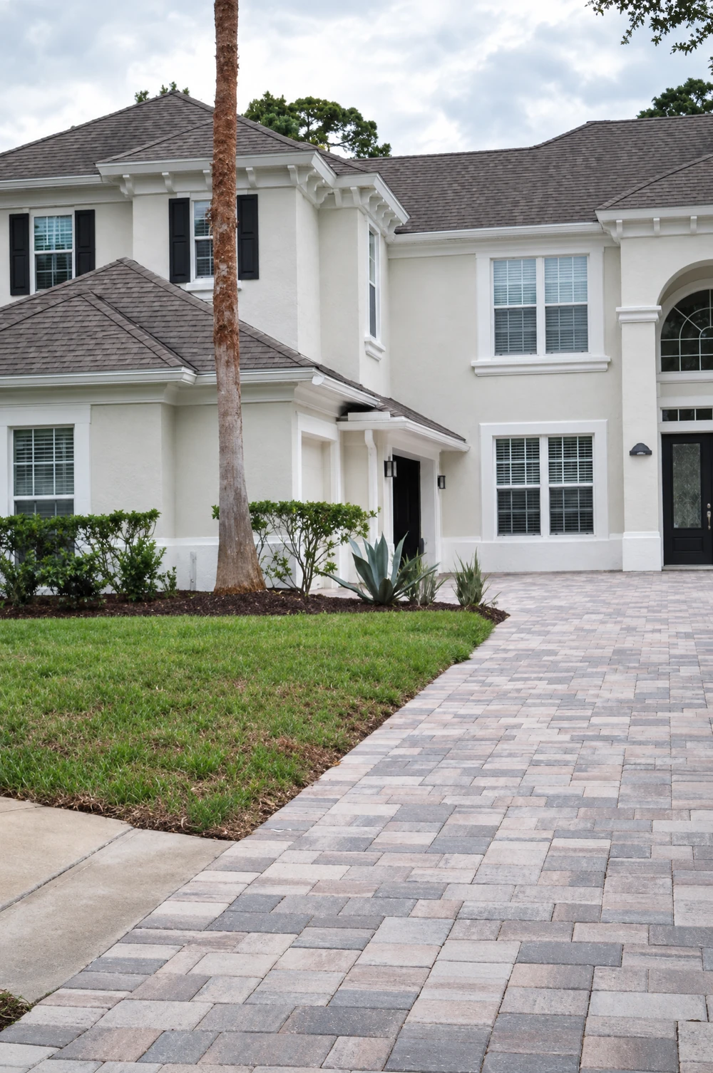 Paver driveway and landscaped home exterior