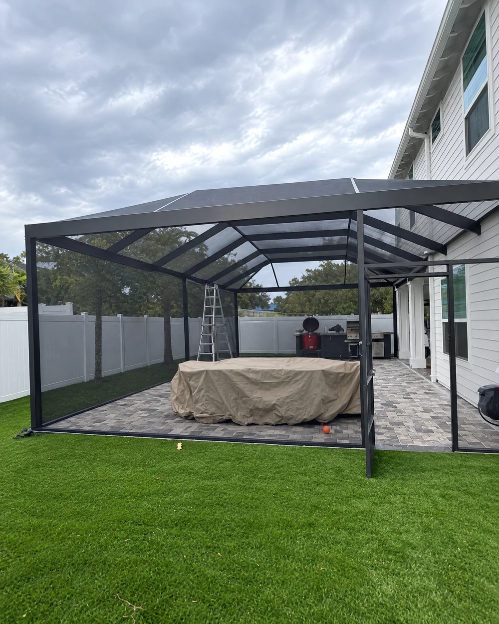 Screen enclosure around a pool